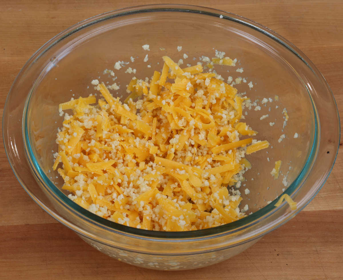 Panko breadcrumbs, melted butter and shredded cheddar cheese in a small bowl.