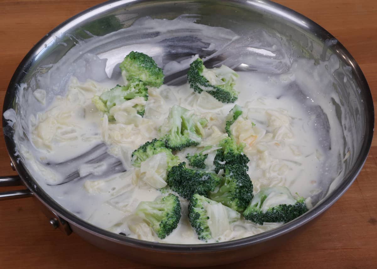 casserole sauce with broccoli added and  simmering in a skillet.