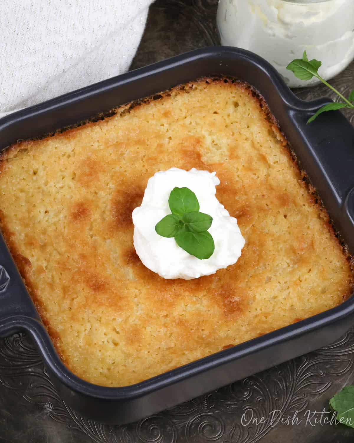 a small buttermilk pie topped with whipped cream.