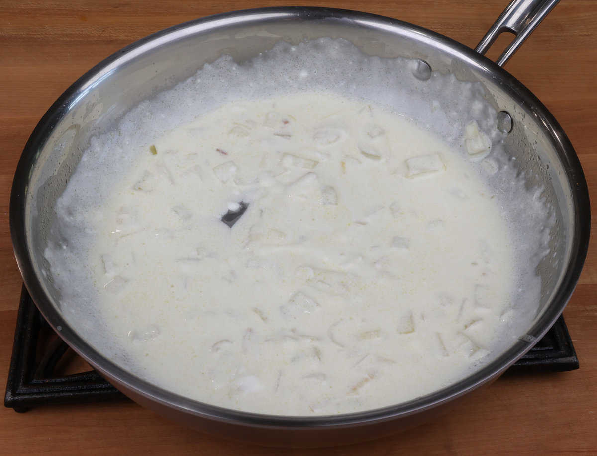 cream sauce for hashbrown casserole cooling in a skillet