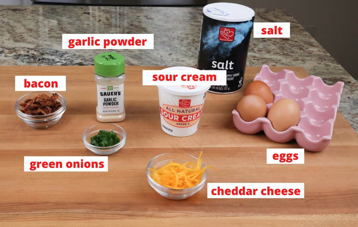 ingredients in loaded deviled eggs on a kitchen counter.