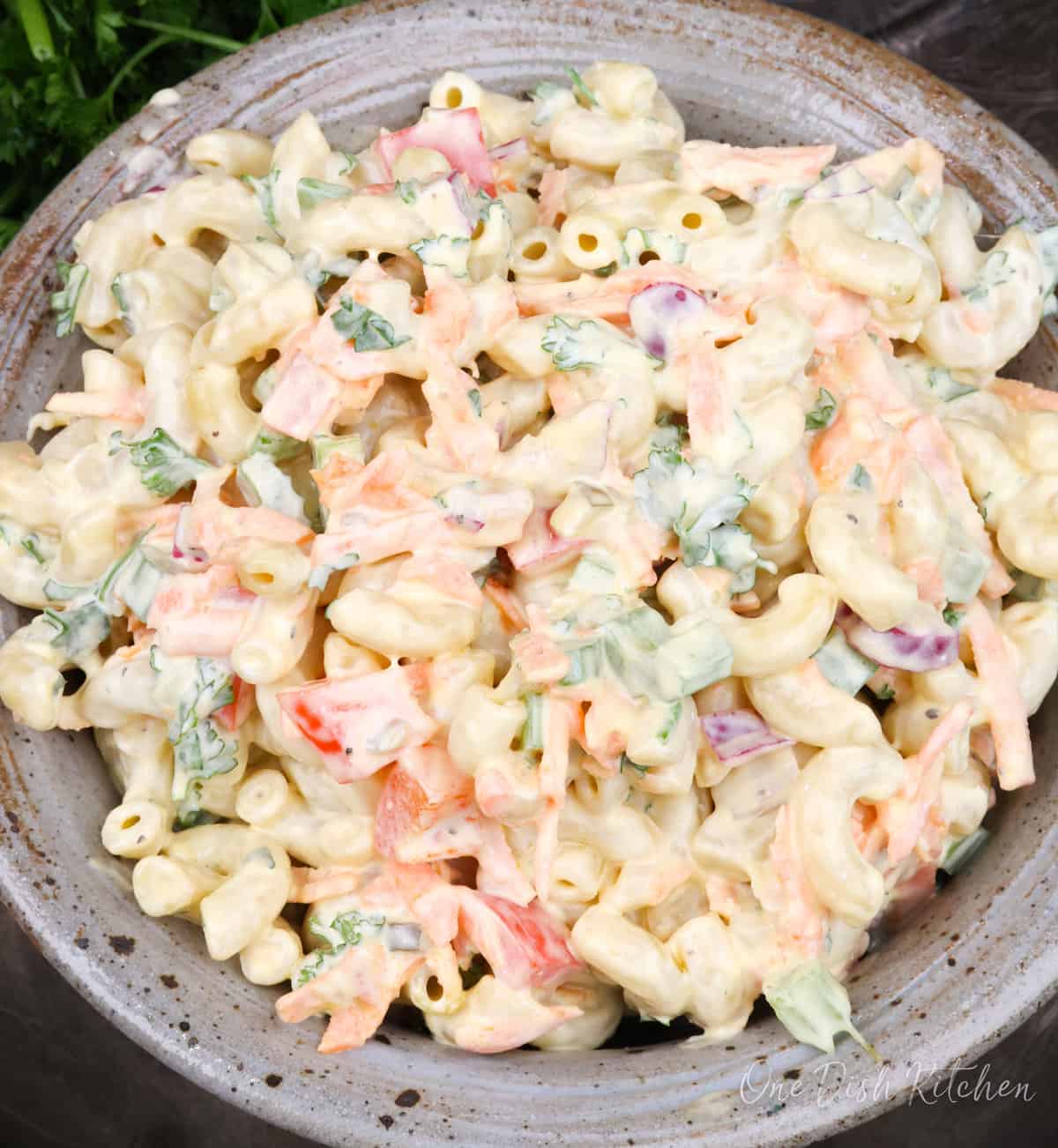 a single serving of macaroni salad in a blue bowl.