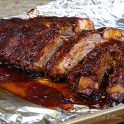 a single serving of oven baked ribs topped with barbecue sauce.
