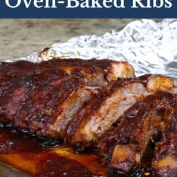 a half rack of baked ribs in foil on a baking sheet.