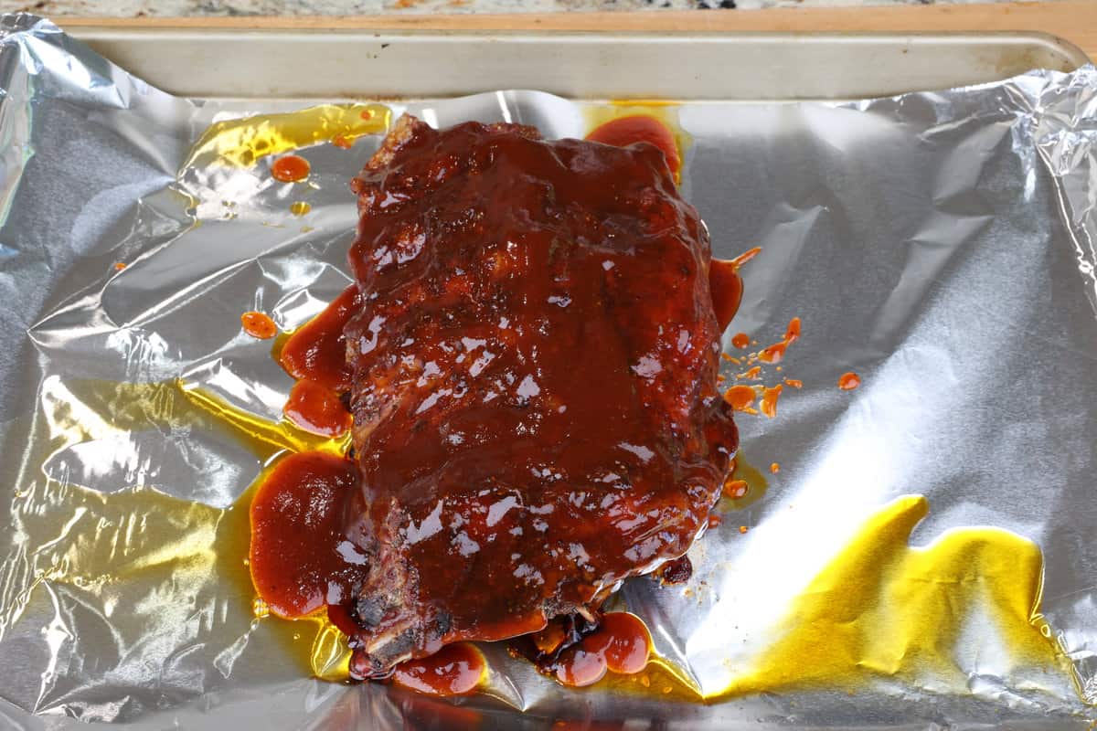 partially baked ribs smothered with bbq sauce