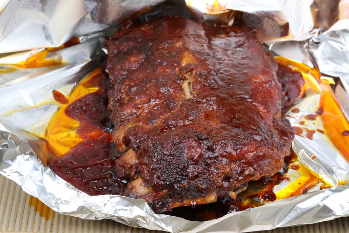 a half rack of oven baked ribs on a baking sheet.