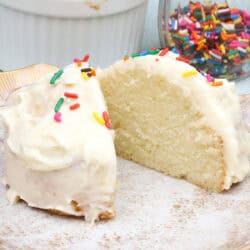 a small white cake cut in half on a plate.