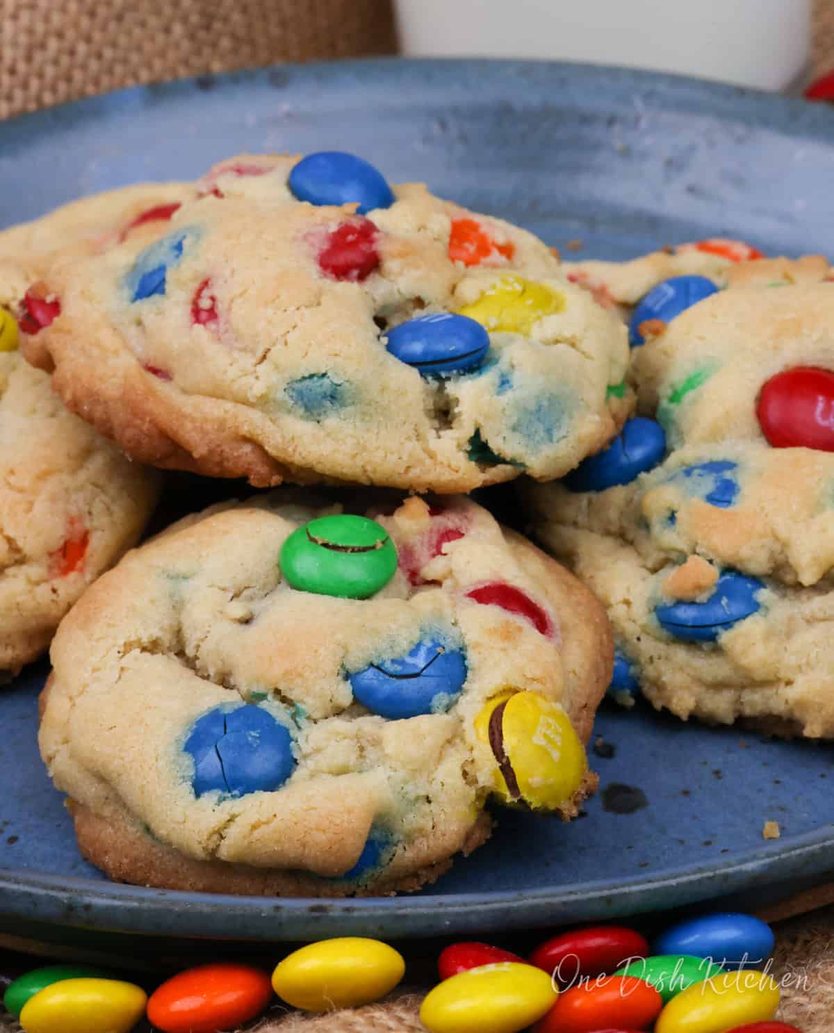 a small batch of m&m cookies on a blue plate.
