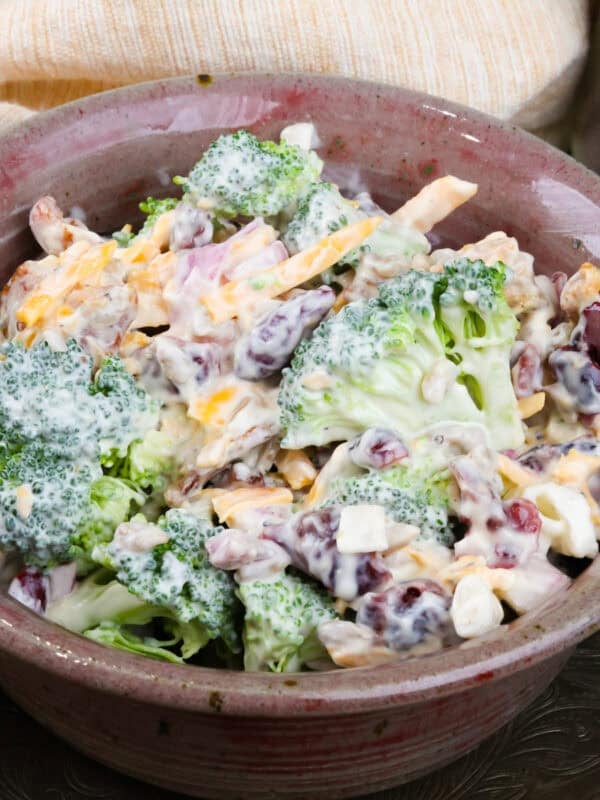 a small broccoli salad topped with a creamy dressing in a bowl.