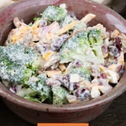 broccoli salad with cheese and dried fruit in a bowl.