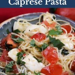 a bowl of caprese pasta next to a red napkin.