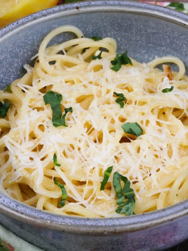 a single serving of pasta al limone topped with fresh parmesan cheese.