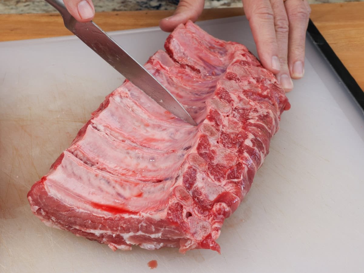 slicing raw ribs.