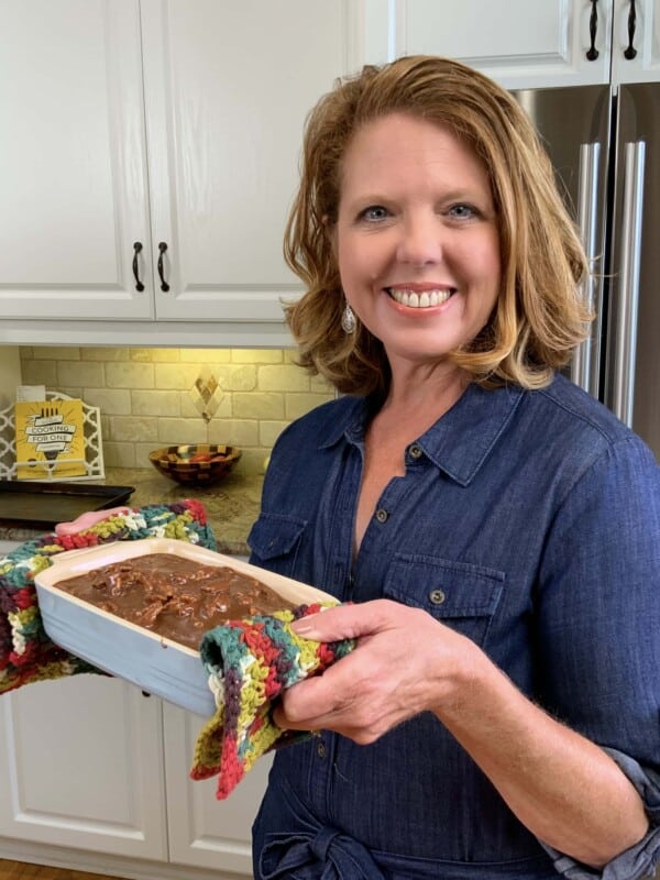 Joanie holding a Texas sheet cake in a baking dish