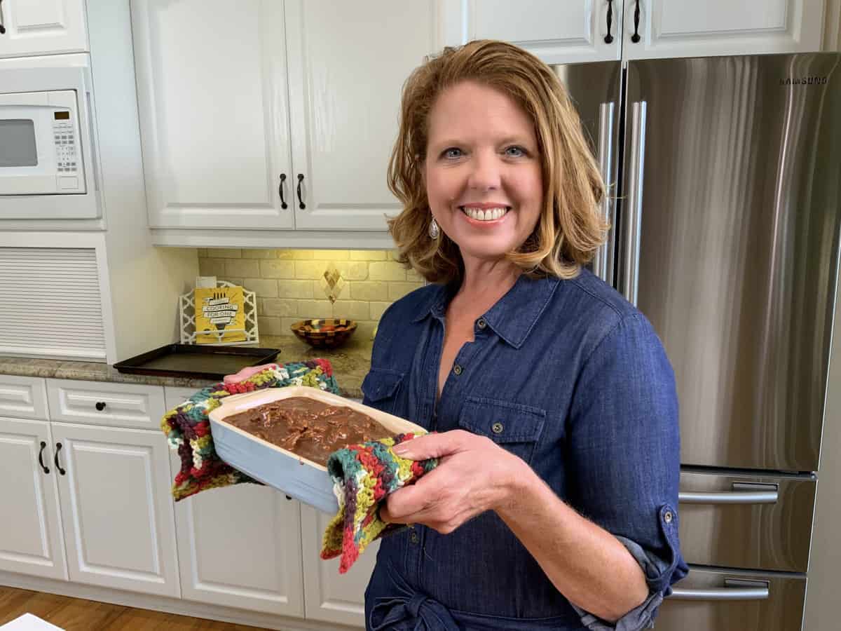 Joanie holding a Texas sheet cake in a baking dish