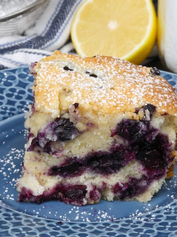 a slice of blueberry cake on a blue plate.