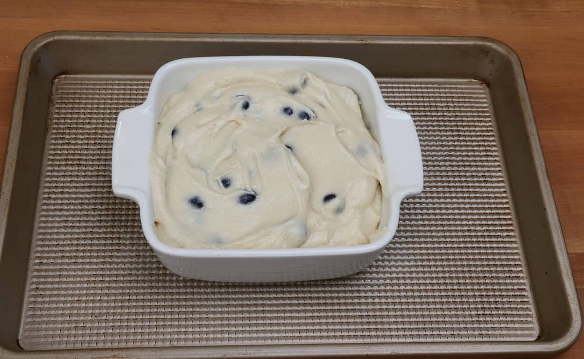 blueberry cake batter in a small baking dish.