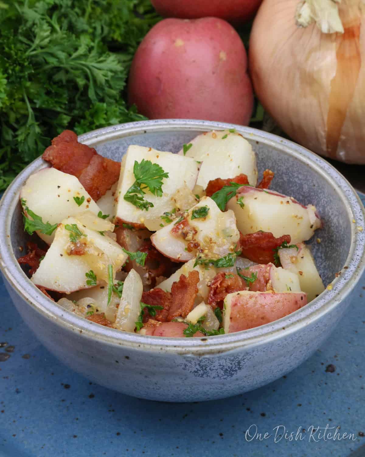 a bowl of authentic german potato salad with bacon dressing.