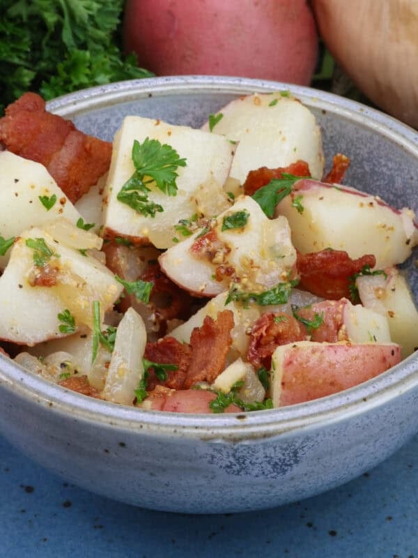 a bowl of authentic german potato salad with bacon dressing.
