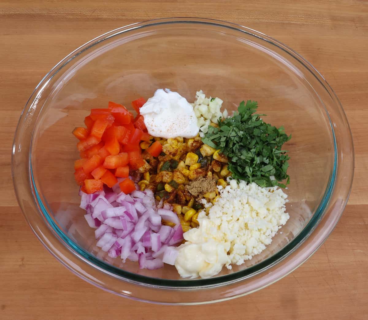 ingredients for mexican street corn salad in a large bowl.