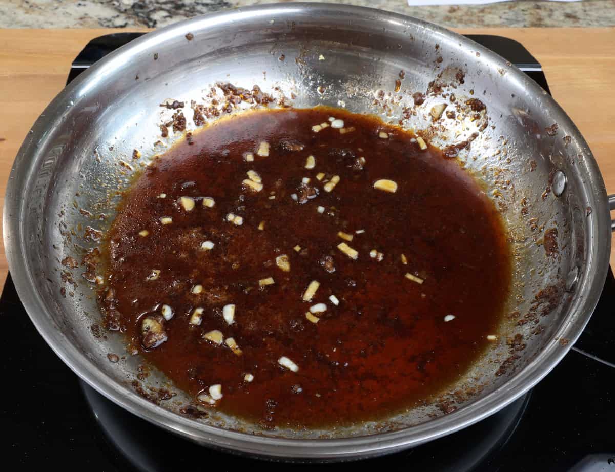mongolian beef sauce simmering in a pan.