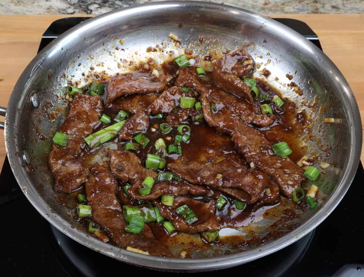 chopped green onions over the top of mongolian beef.