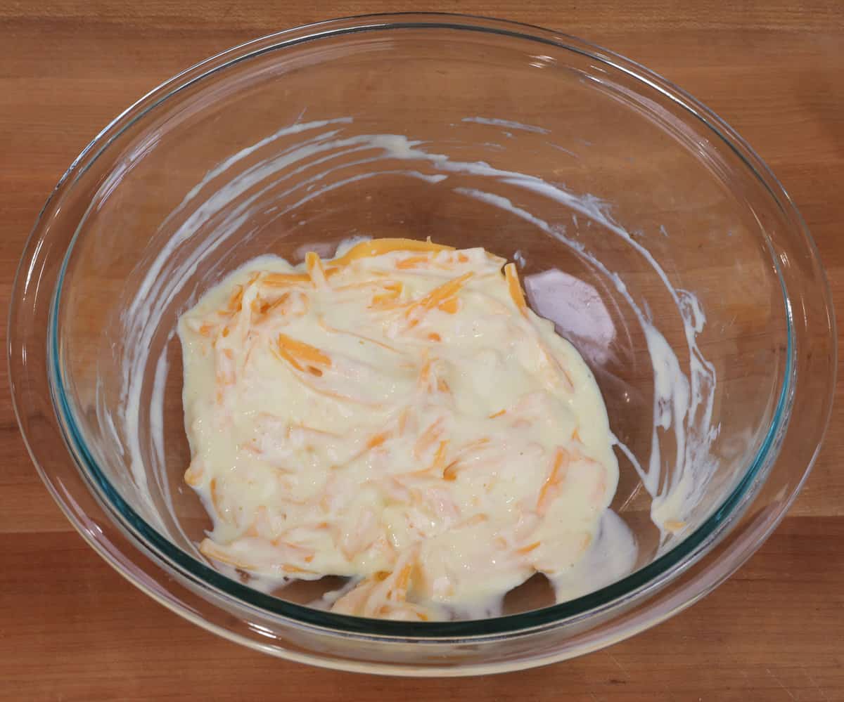 egg, sour cream, mayonnaise, and shredded cheddar cheese in a small bowl.