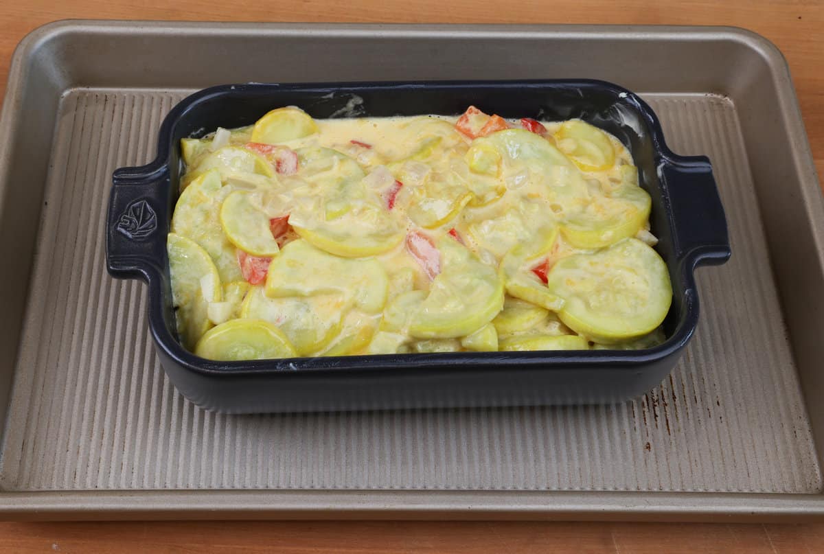 unbaked squash casserole in a small baking dish.