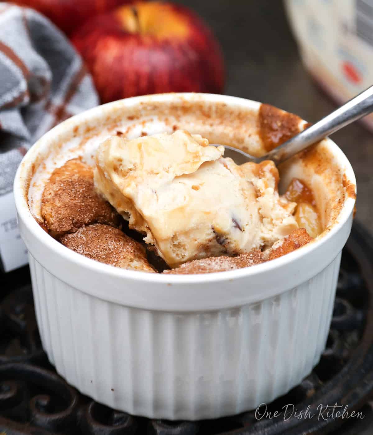 an apple cobbler topped with ice cream.