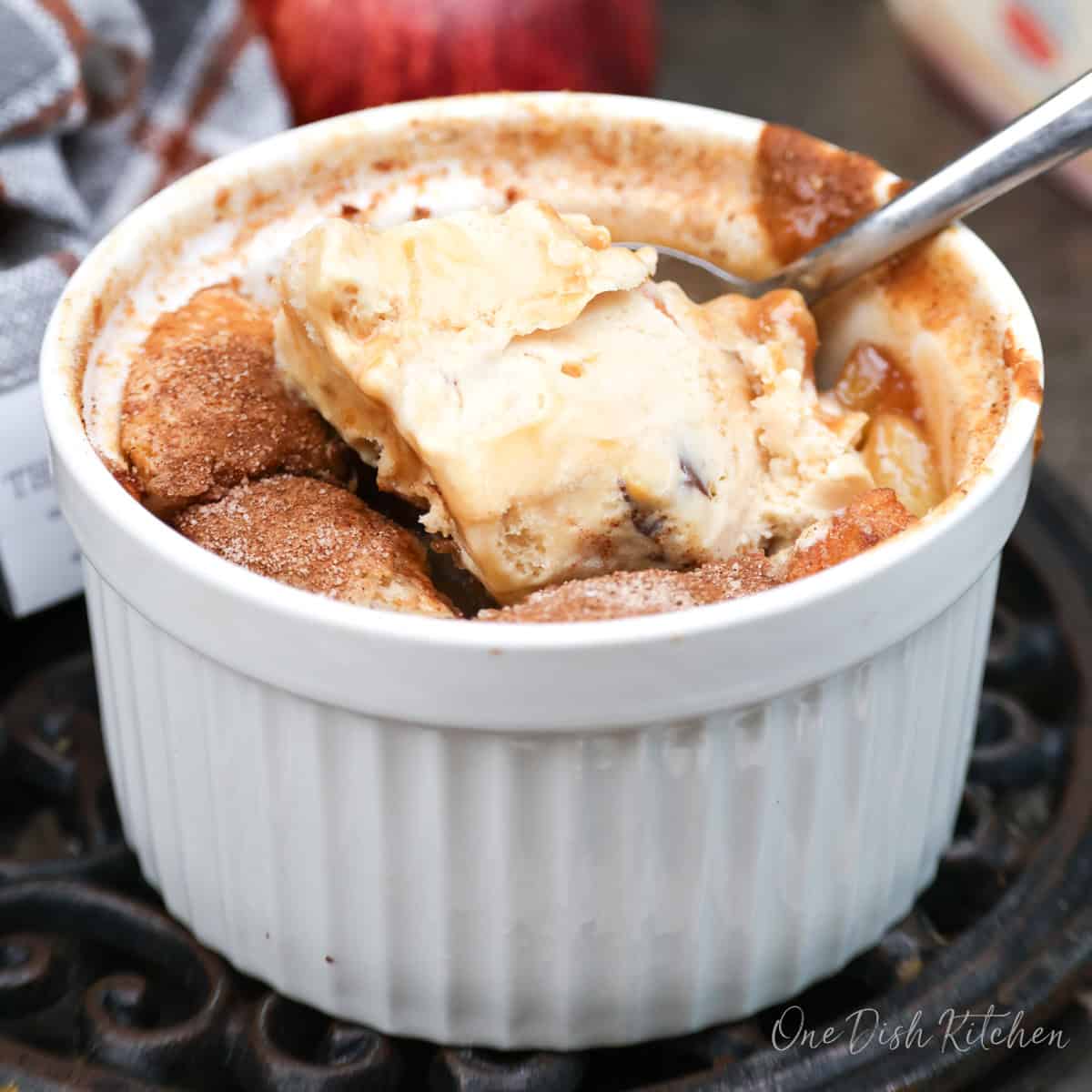 an apple cobbler topped with ice cream.