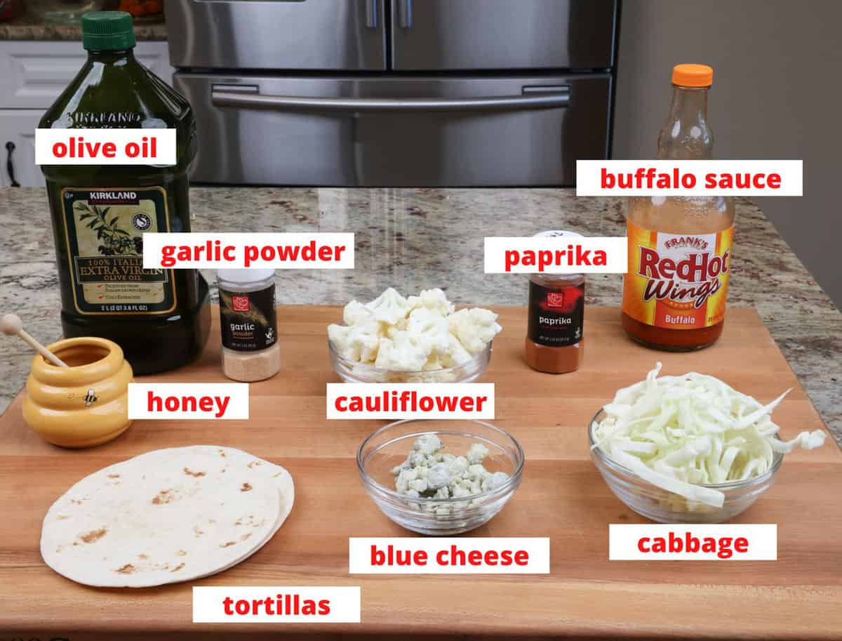 buffalo cauliflower tacos ingredients on a kitchen counter.