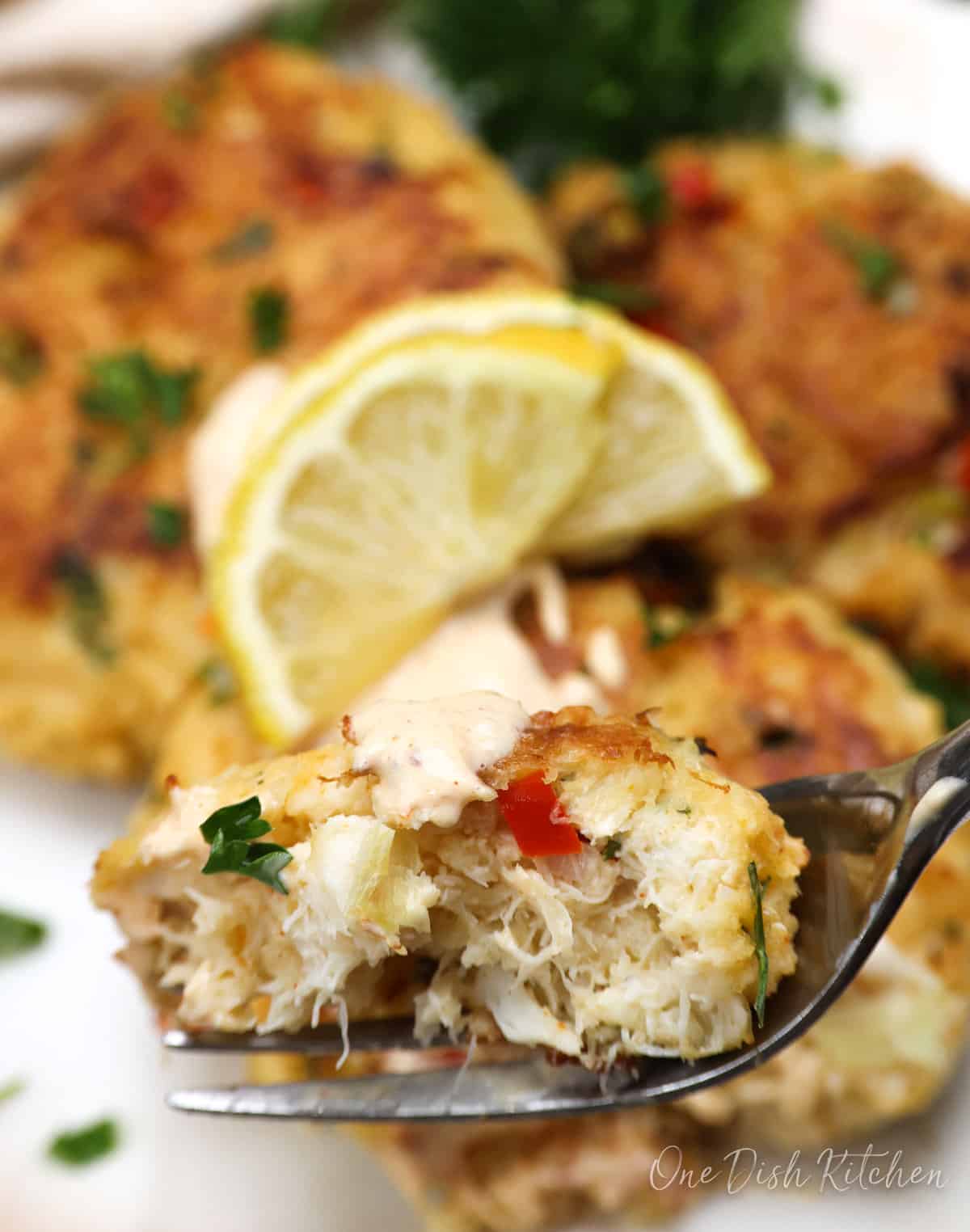 a part of a crab cake on a fork.