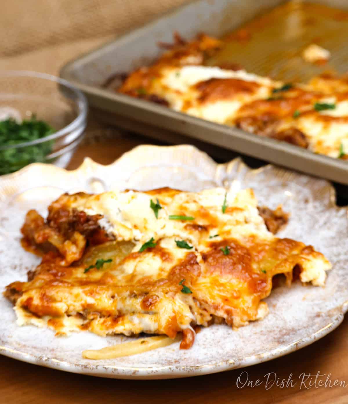 a plate of layerless lasagna next to a sheetpan.