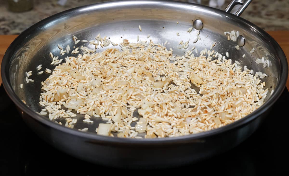 rice and onions in a skillet.