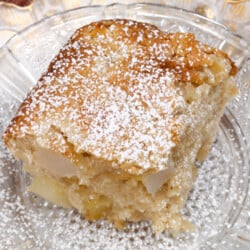 slice of mini apple cake with powdered sugar on top.