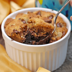 a spoonful of brownie and cookie above a brookie in a ramekin.