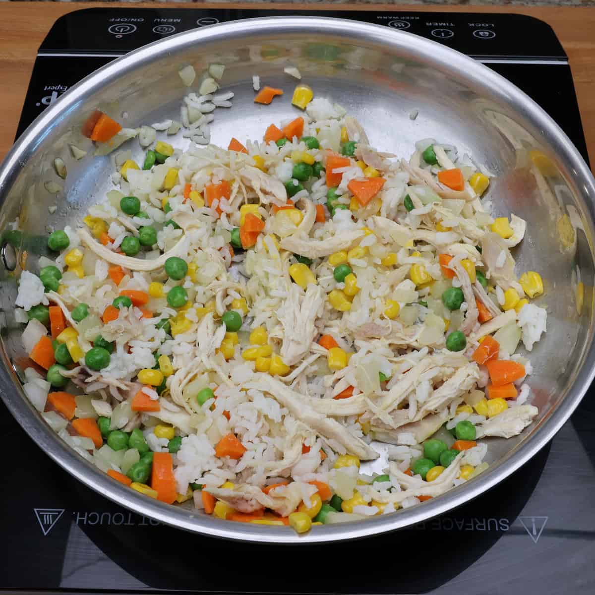 Fried rice cooking in a skillet.