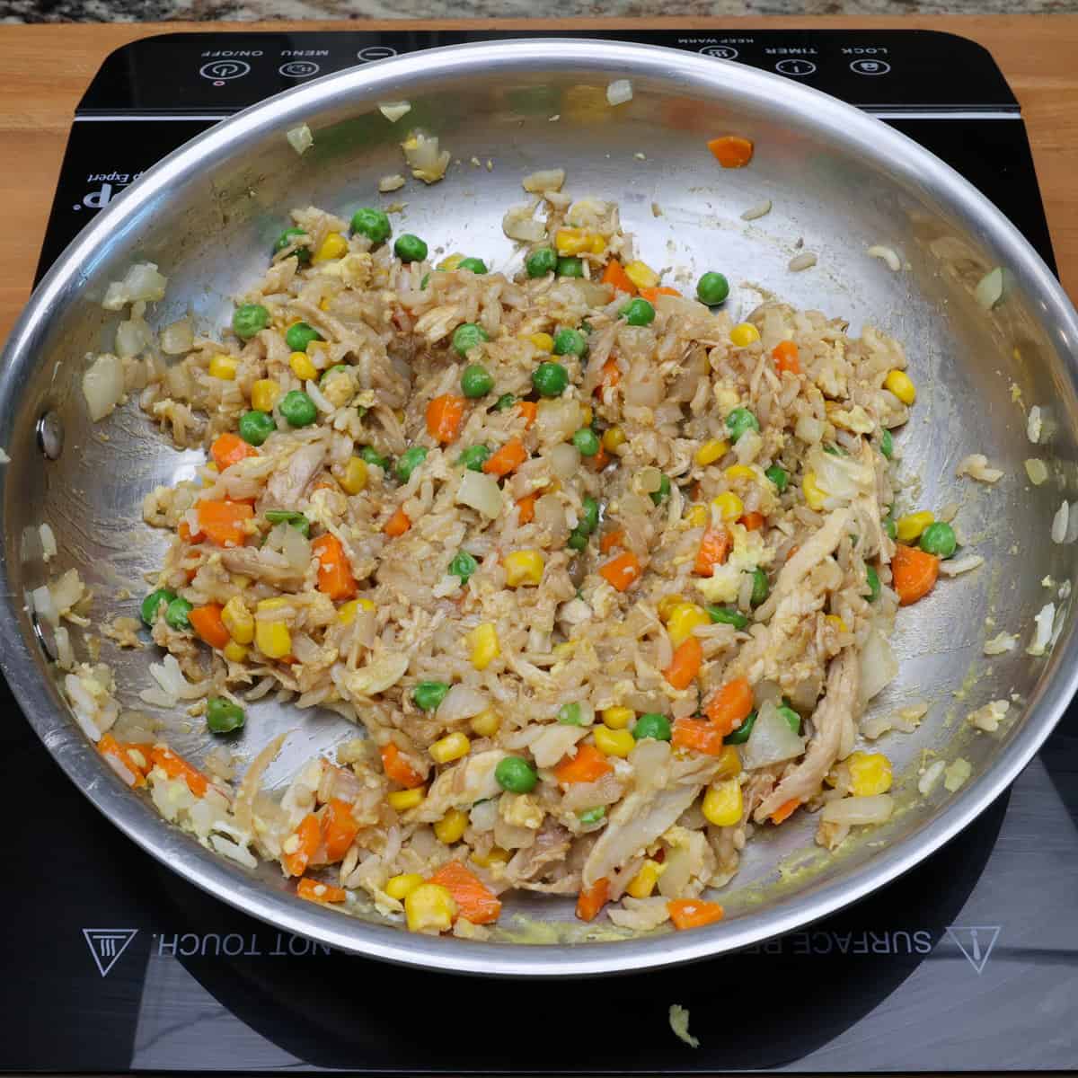 chicken fried rice with oyster sauce in a skillet.