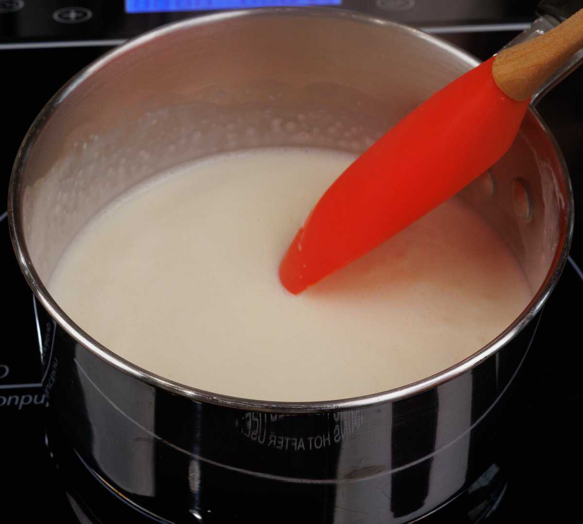 heavy cream and lemon juice simmering in a pot on the stove.