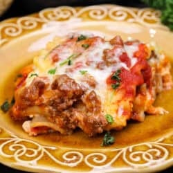 a single lasagna rollup on a gold plate.