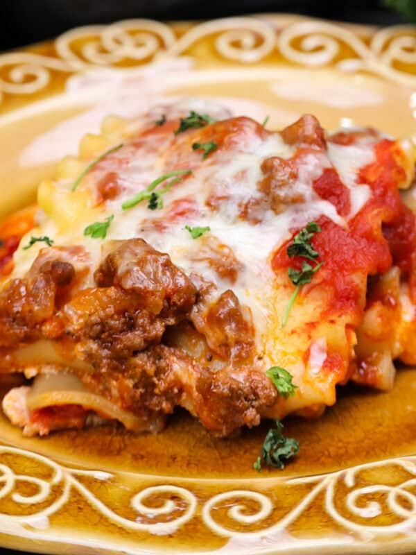 a single lasagna rollup on a gold plate.