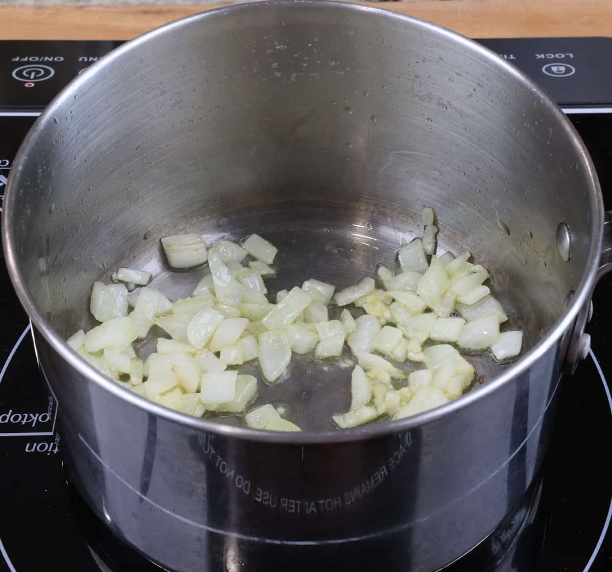 onions and garlic cooking in a pot.