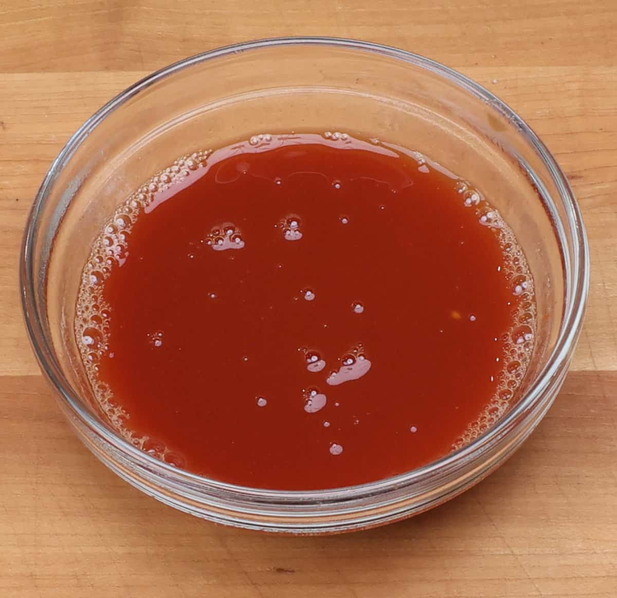 tomato paste and beef broth mixed together in a small bowl.