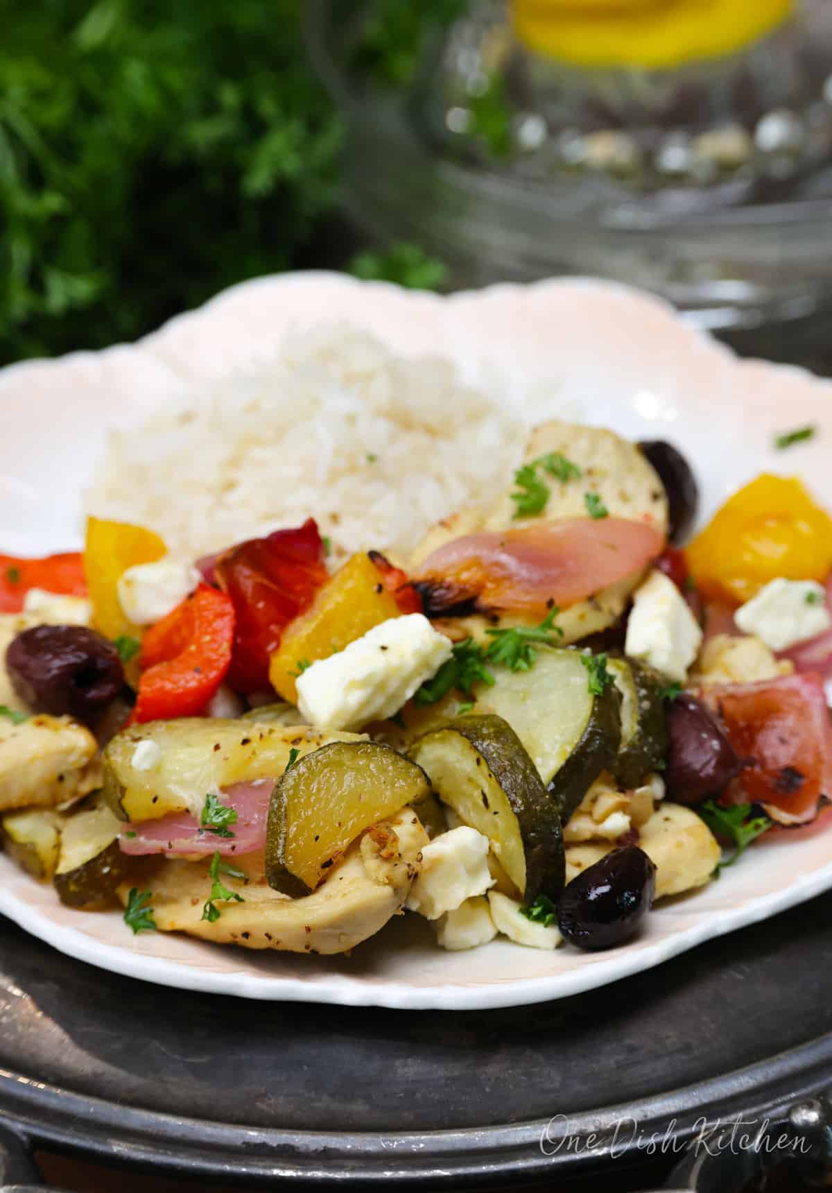 greek chicken on a plate with rice.
