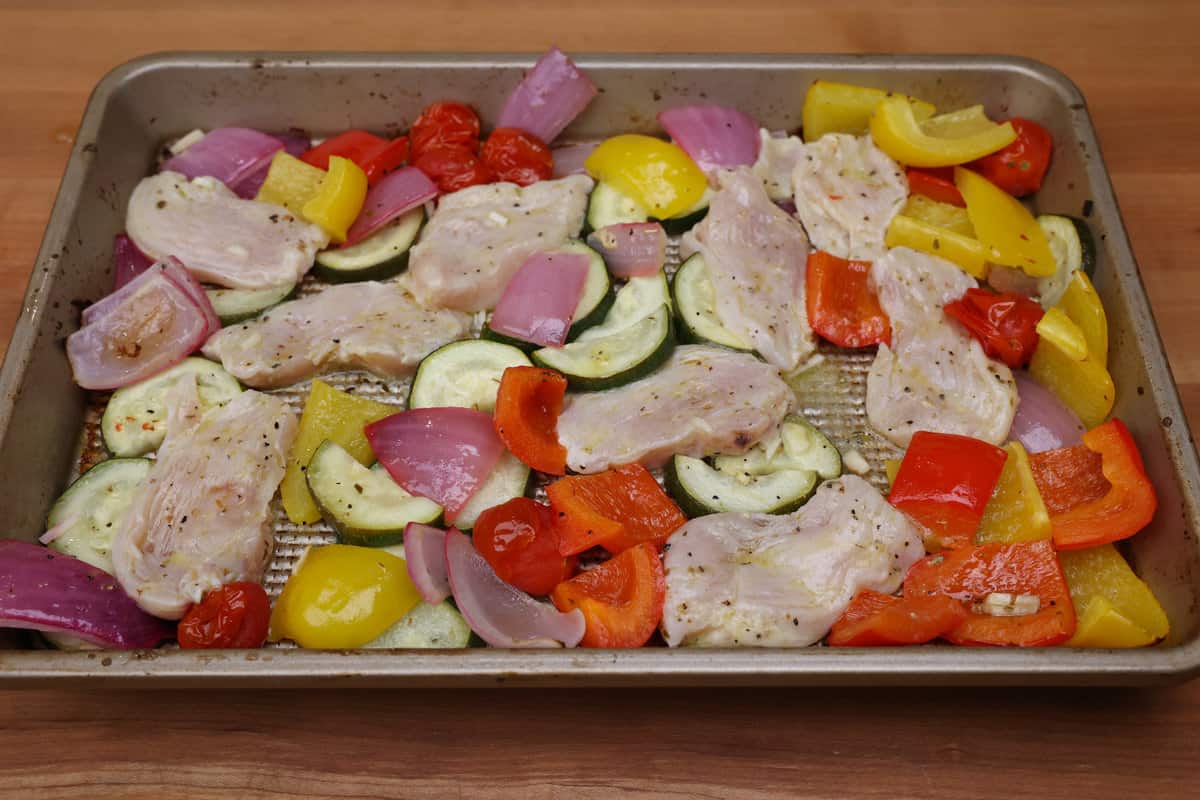 chicken and vegetables on a sheet pan.