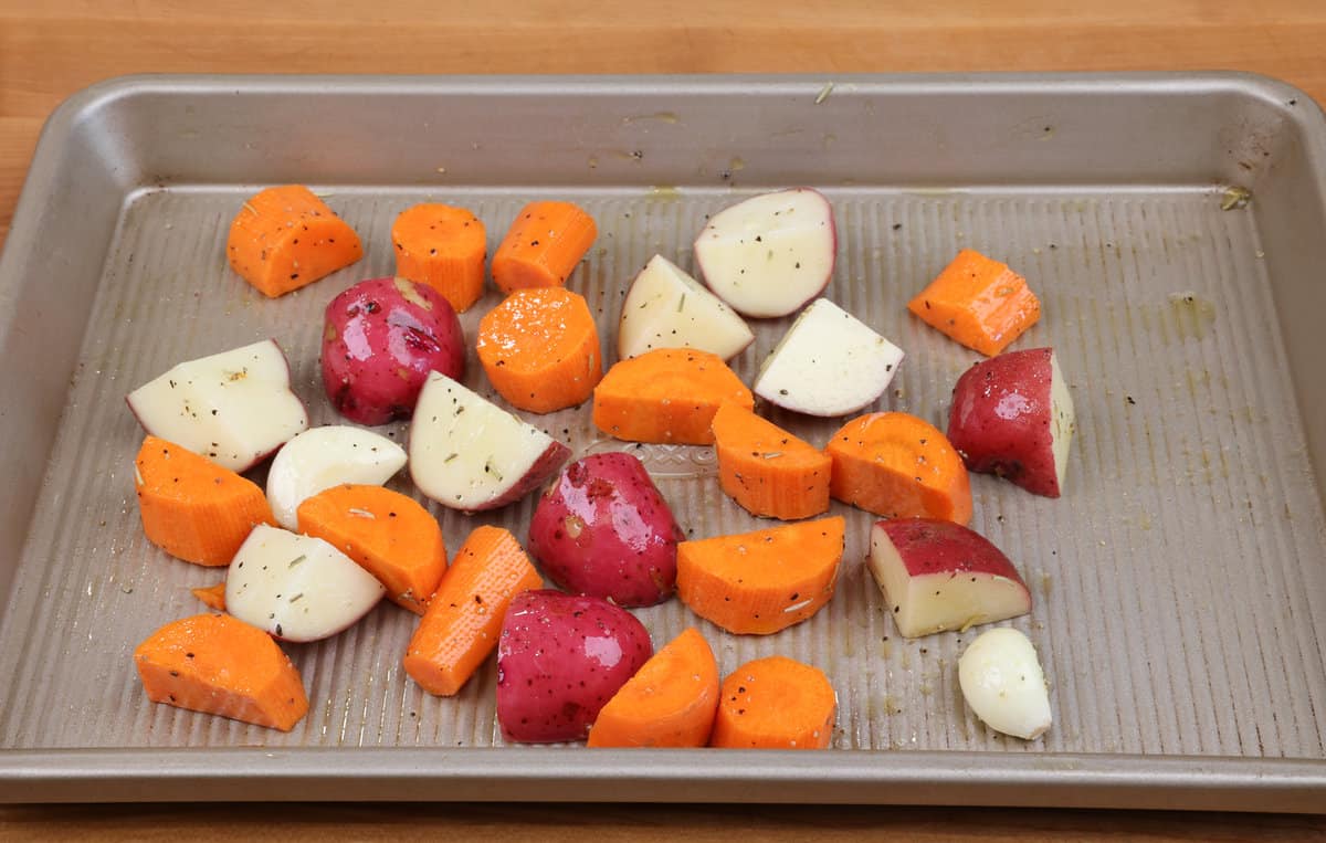 carrots and potatoes on a sheet pan.