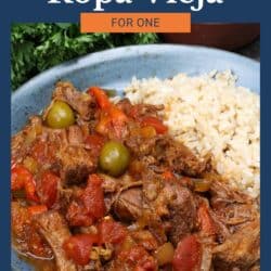 ropa vieja with rice in a blue bowl.