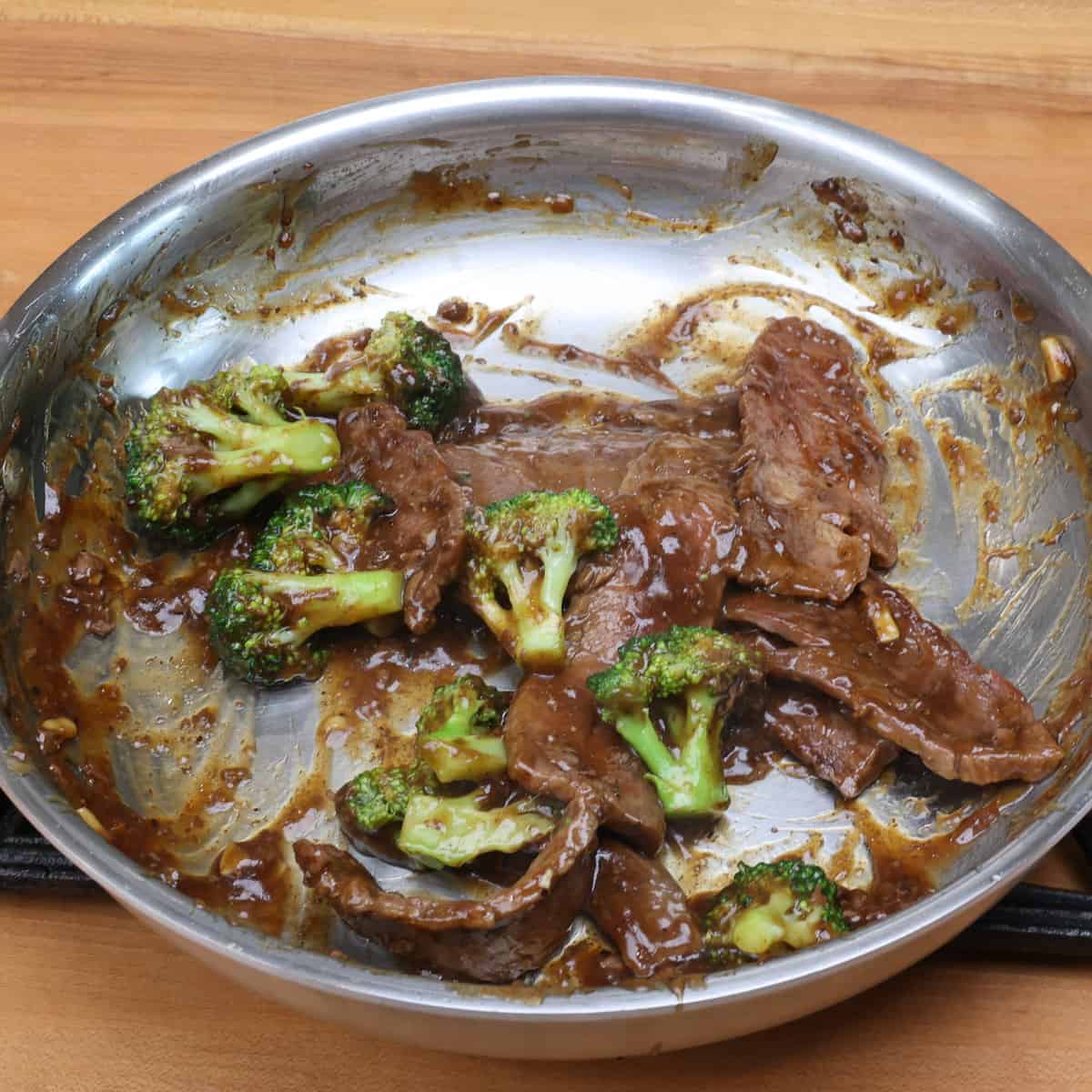 beef and broccoli simmering in a stir fry sauce.