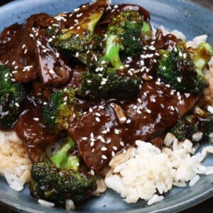 beef and broccoli topped with sesame seeds over white rice.