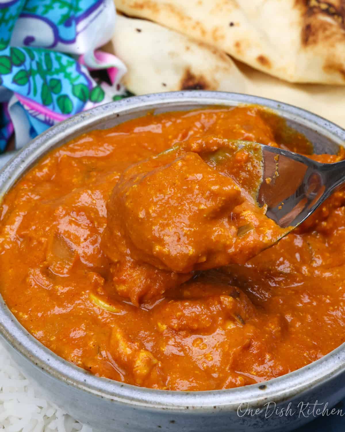 a blue bowl filled with chicken tikka masala.